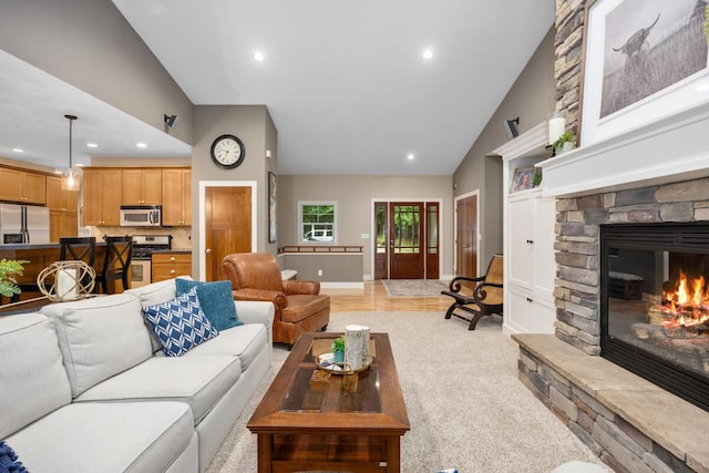 8702 E 98th St, Howard City, MI 49329 - living room featuring recessed lighting, a fireplace, high vaulted ceiling, and light carpet