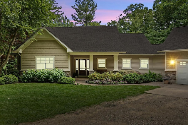 8702 E 98th St, Howard City, MI 49329 - craftsman house with a front lawn, driveway, roof with shingles, and stone siding