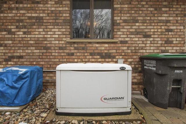 details featuring a power unit and brick siding