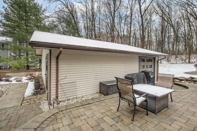 snow covered patio featuring outdoor dining space