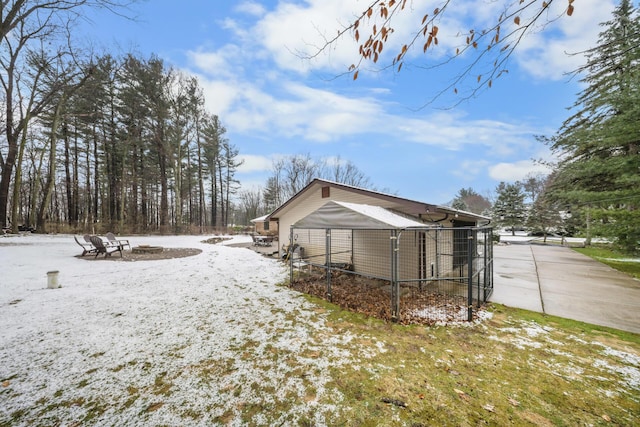 snow covered property featuring an outdoor fire pit