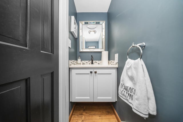 bathroom with wood finished floors and vanity