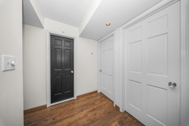hall with dark wood finished floors and baseboards