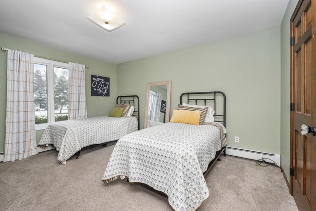 bedroom featuring baseboard heating and carpet floors
