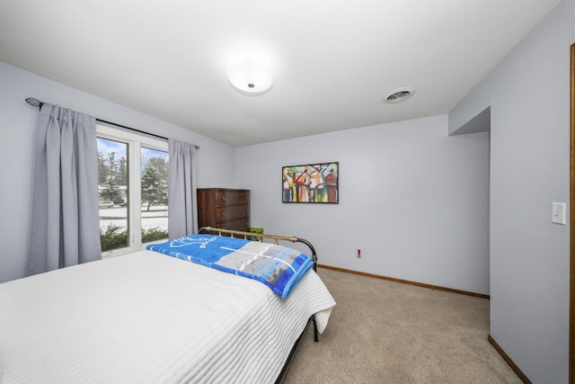 bedroom with carpet floors, visible vents, and baseboards