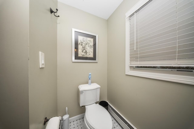 bathroom with a baseboard heating unit, marble finish floor, baseboards, and toilet