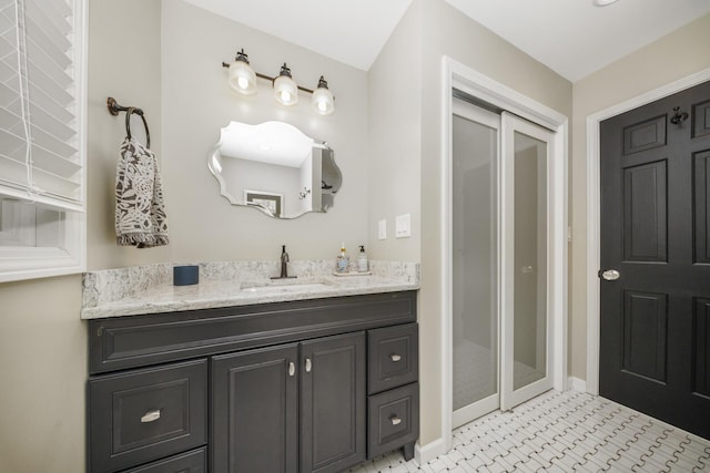 bathroom with baseboards and vanity