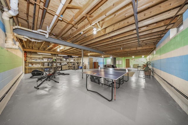 playroom featuring concrete floors and concrete block wall