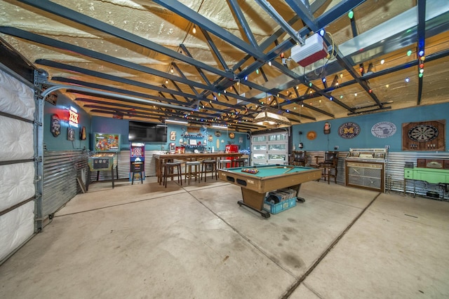 rec room with a garage, pool table, concrete floors, and a workshop area
