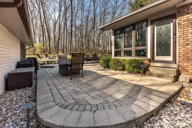 view of patio featuring outdoor dining space and entry steps