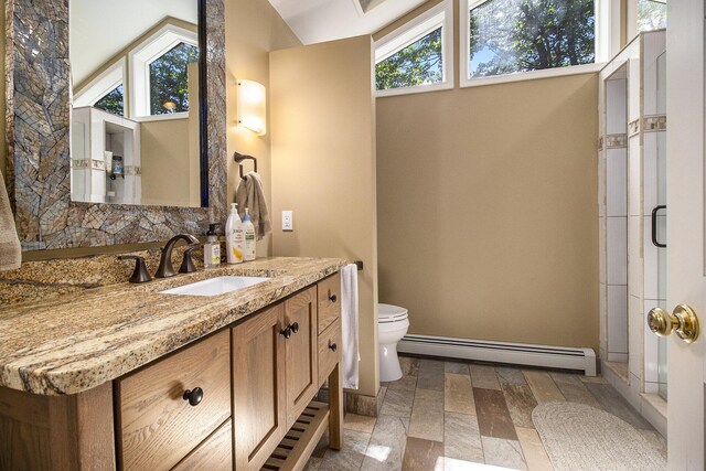 5410 Oak Ridge Rd, Ludington, MI 49431 - bathroom with toilet, a baseboard heating unit, lofted ceiling, and vanity