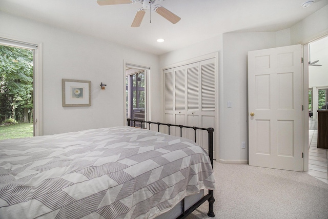 5410 Oak Ridge Rd, Ludington, MI 49431 - carpeted bedroom with a closet, access to exterior, multiple windows, and a ceiling fan
