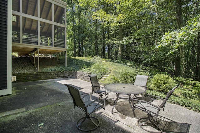 5410 Oak Ridge Rd, Ludington, MI 49431 - view of patio / terrace featuring outdoor dining space and a sunroom
