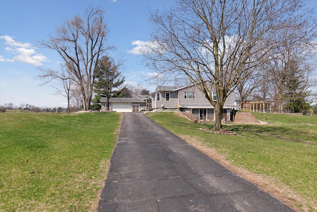 846 Morton Rd, Horton, MI 49246 - tri-level home with an attached garage, aphalt driveway, and a front lawn