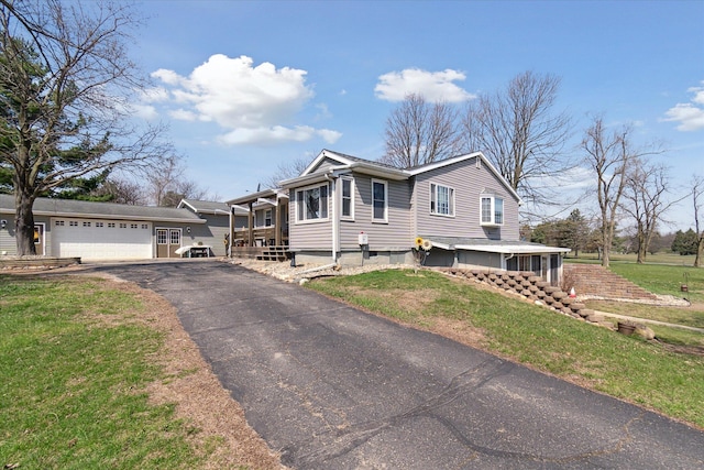 846 Morton Rd, Horton, MI 49246 - view of front facade with a front yard, an attached garage, and aphalt driveway