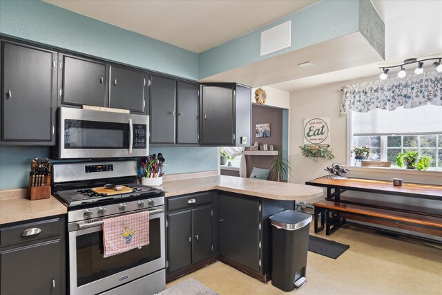 846 Morton Rd, Horton, MI 49246 - kitchen with a wealth of natural light, a peninsula, light countertops, and appliances with stainless steel finishes
