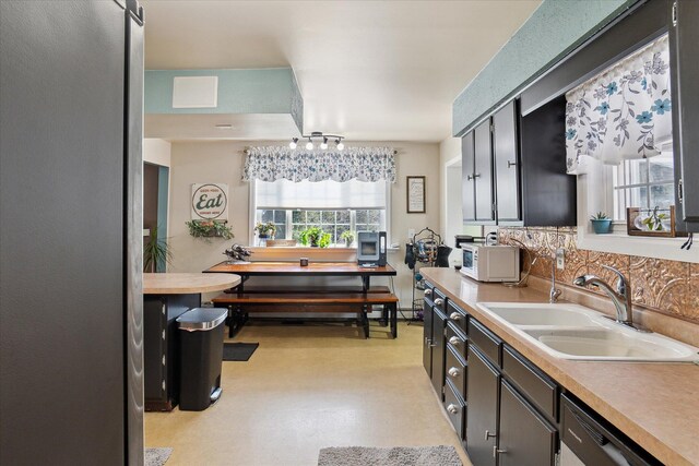 846 Morton Rd, Horton, MI 49246 - kitchen with dishwasher, a sink, light countertops, freestanding refrigerator, and decorative backsplash