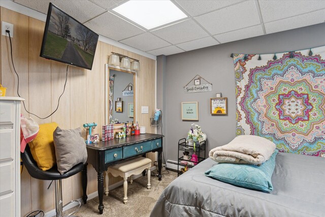 846 Morton Rd, Horton, MI 49246 - bedroom with wood walls, carpet, a drop ceiling, and a baseboard radiator