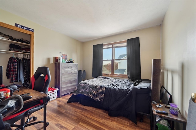 bedroom with a closet and wood finished floors