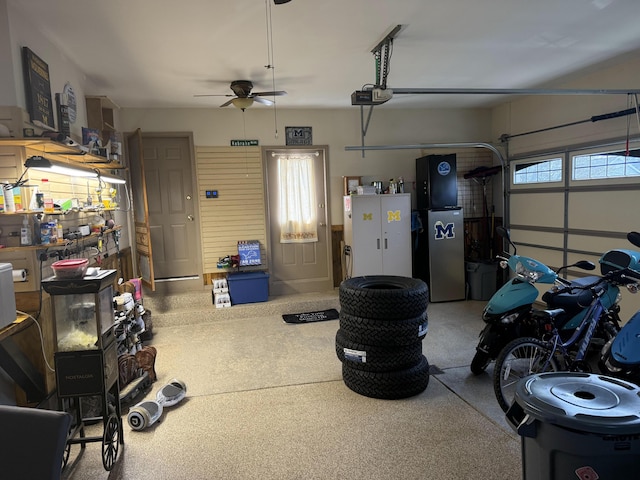 garage with freestanding refrigerator, a ceiling fan, and a garage door opener