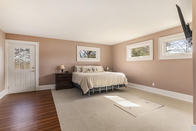 bedroom featuring baseboards and dark wood-style floors