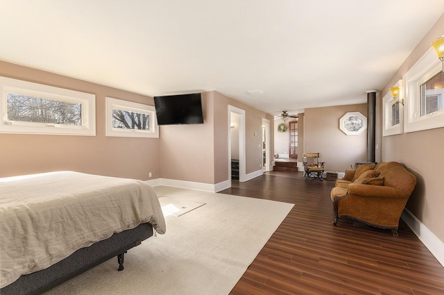 bedroom featuring baseboards and dark wood-style floors