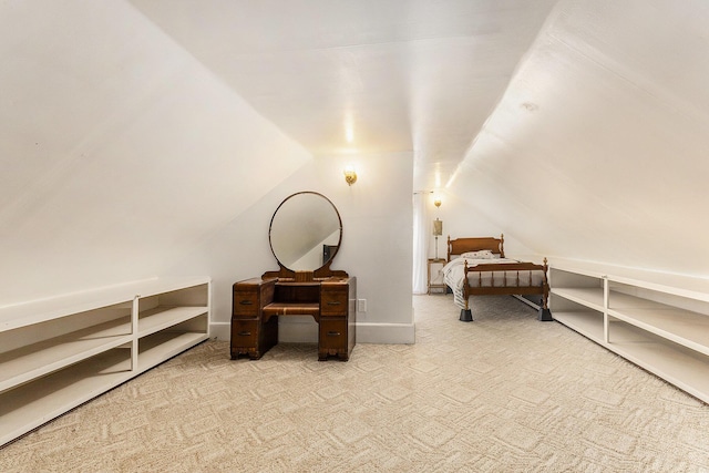 carpeted bedroom with lofted ceiling