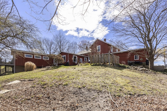 exterior space with a wooden deck and a chimney