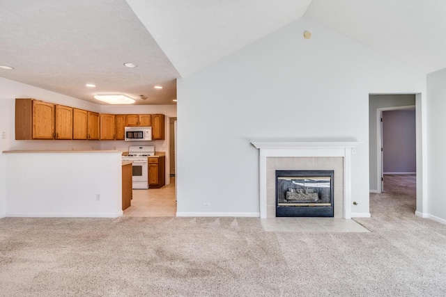 unfurnished living room with baseboards, a fireplace, recessed lighting, vaulted ceiling, and light carpet