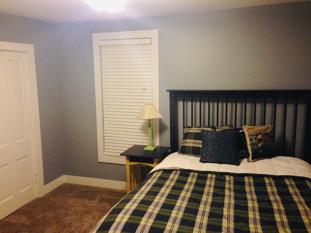 201 E Danaher St, Ludington, MI 49431 - carpeted bedroom featuring baseboards