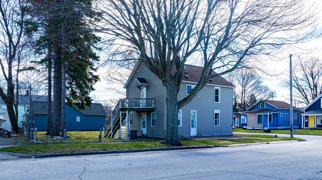 201 E Danaher St, Ludington, MI 49431 - view of front of house featuring stairs and a residential view