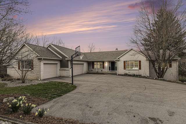 10159 E Rivershore Dr SE, Alto, MI 49302 - ranch-style house featuring a garage, aphalt driveway, and brick siding