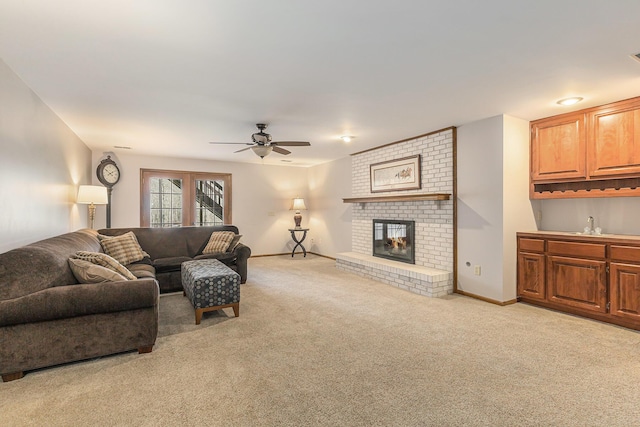10159 E Rivershore Dr SE, Alto, MI 49302 - living room with a brick fireplace, light colored carpet, baseboards, and ceiling fan