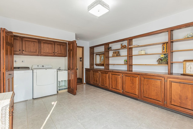 10159 E Rivershore Dr SE, Alto, MI 49302 - clothes washing area with washer and dryer, light tile patterned flooring, and cabinet space
