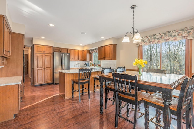 10159 E Rivershore Dr SE, Alto, MI 49302 - dining room with a healthy amount of sunlight, a notable chandelier, dark wood finished floors, and recessed lighting