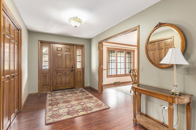 10159 E Rivershore Dr SE, Alto, MI 49302 - entryway with dark wood-style flooring, baseboards, and visible vents