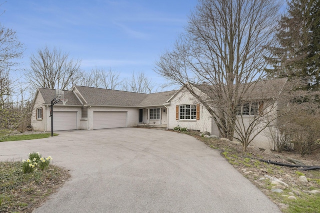 10159 E Rivershore Dr SE, Alto, MI 49302 - ranch-style home featuring an attached garage, driveway, and brick siding