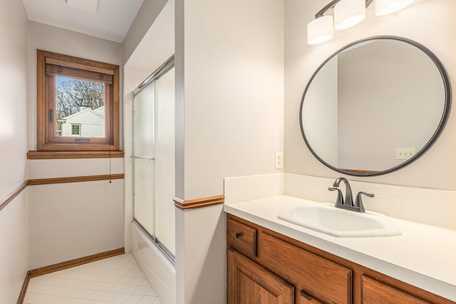 10159 E Rivershore Dr SE, Alto, MI 49302 - bathroom with tile patterned floors, vanity, baseboards, and shower / bath combination with glass door