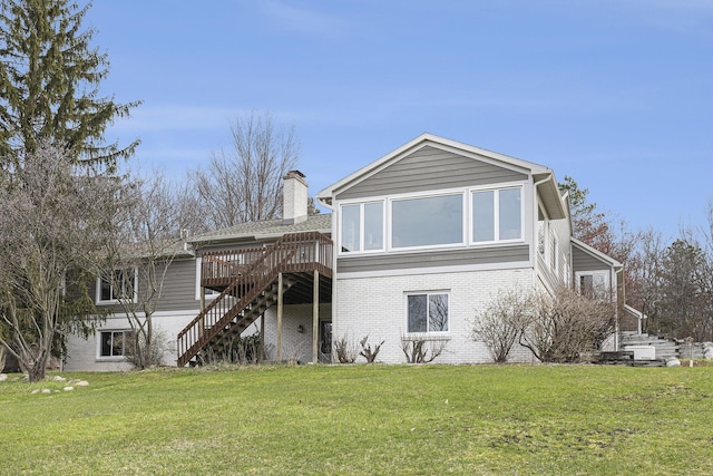 10159 E Rivershore Dr SE, Alto, MI 49302 - rear view of property featuring a yard, a chimney, stairs, brick siding, and a wooden deck