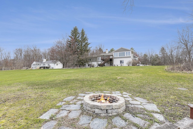 10159 E Rivershore Dr SE, Alto, MI 49302 - view of yard with an outdoor fire pit and stairway