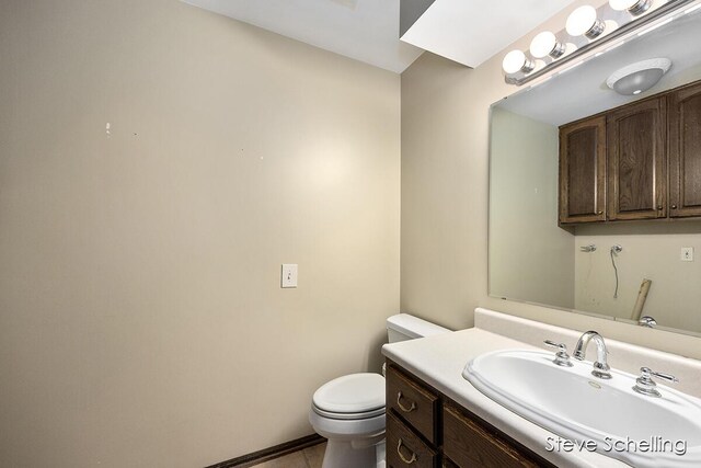 bathroom featuring toilet and vanity