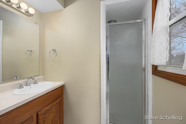 bathroom with vanity and a shower stall