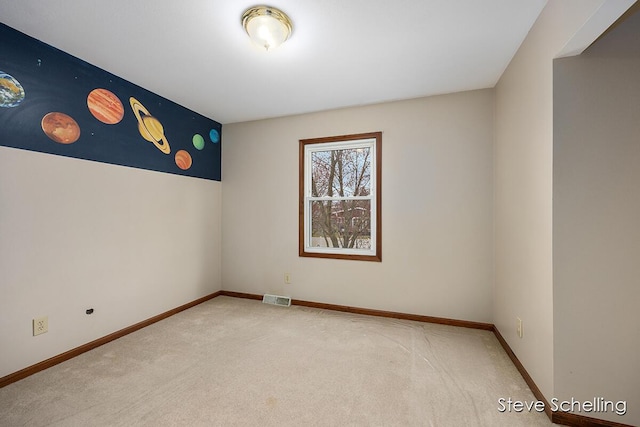 unfurnished room with carpet floors, baseboards, and visible vents