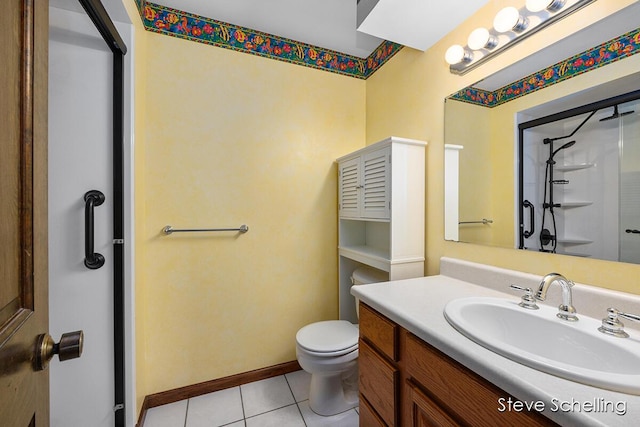 bathroom featuring vanity, tile patterned floors, a stall shower, and toilet
