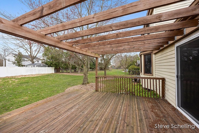 deck featuring a lawn, a pergola, and fence
