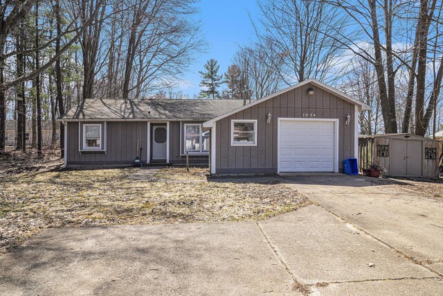 1034 Leo St, Fremont, MI 49412 - ranch-style home featuring board and batten siding, driveway, a shed, and an outdoor structure