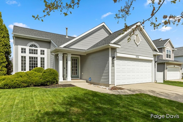 ranch-style house with an attached garage, a shingled roof, a front lawn, and concrete driveway