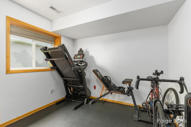 workout room featuring baseboards and visible vents