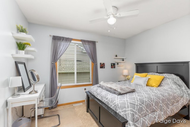 bedroom featuring baseboards, visible vents, a ceiling fan, and light colored carpet