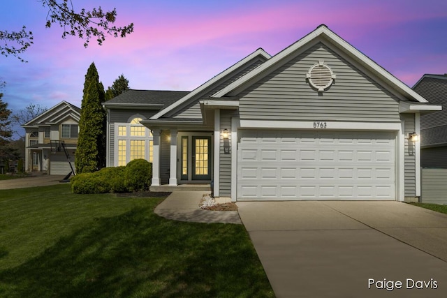 single story home featuring a garage, concrete driveway, and a front lawn